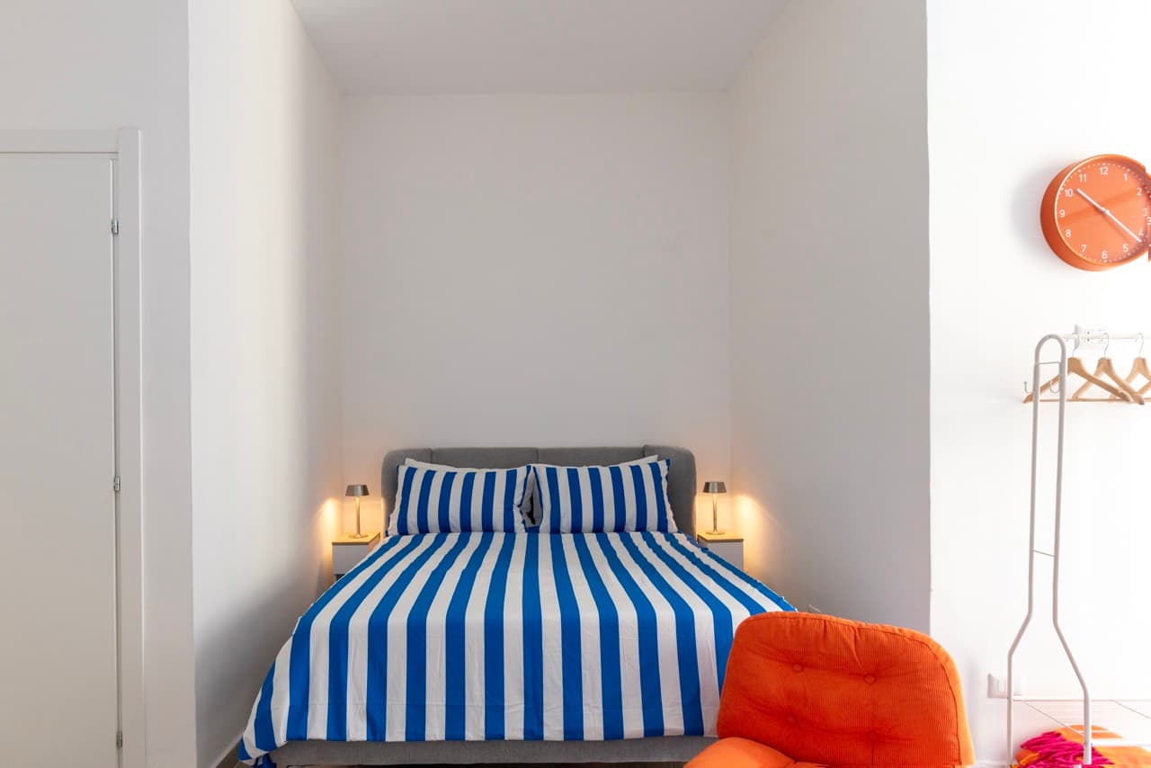 Living area with orange chair and balcony light